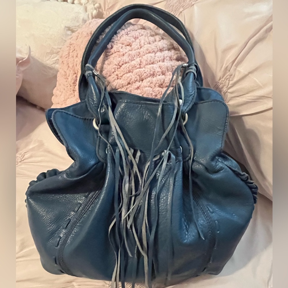 Blue leather Lucky Brand hobo bag with tassels, Magnetic closure & drawstrings.